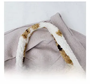 Close-up of fluffy animal print shoulder strap on a soft plush tote bag detail