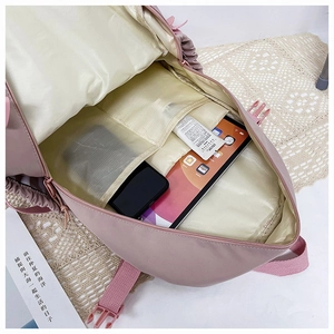 Macro view of the pink waterproof nylon backpack showing large capacity and internal pockets