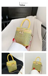 Detail of yellow mini rhinestone box bag with golden chain strap and velvet finish