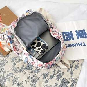 White canvas butterfly backpack for students showing spacious interior and tablet compartment