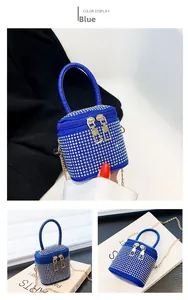 Detail of blue mini bucket bag with sparkling silver rhinestones and gold chain strap