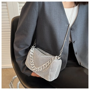 Close-up of a silver rhinestone crossbody bag with thick metallic chain and detail