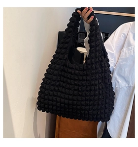 Detailed close-up showing the unique black bubble texture of the pleated canvas tote bag