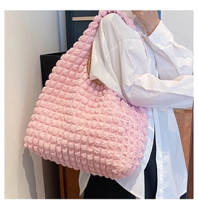 Detail shot of the pink bubble-textured fabric on this stylish ruffled cloud tote bag