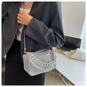 Close-up of sparkling silver rhinestone handbag with chain handle in a modern setting