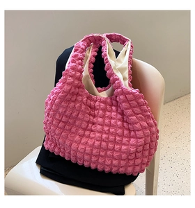 Close-up of pink puff ruffled texture and cream lining on stylish canvas tote bag