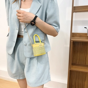Bright yellow mini rhinestone bucket bag with golden chain strap and top handle