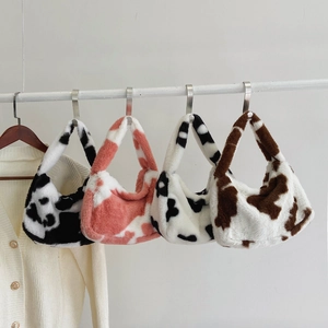 Chic cow print faux fur hobo shoulder bags in various colors on a display rack