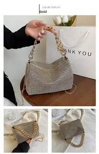 Close-up of sparkling gold rhinestone handbag with thick chunky chain and zipper detail