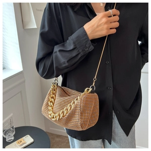 Close-up of sparkling rhinestone handbag with a gold chain strap and crossbody design