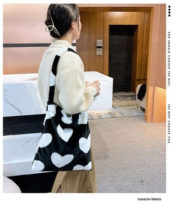Detail of soft plush tote bag featuring a classic black and white heart pattern design