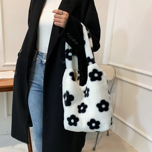 Minimalist white faux fur tote bag with black flower pattern and plush handle