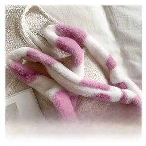Close-up of pink and white checkered faux fur wide shoulder strap for plush bags