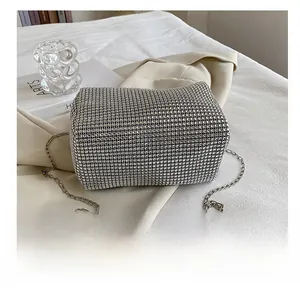 Flat bottom detail of a silver rhinestone evening bag with elegant metal chain strap
