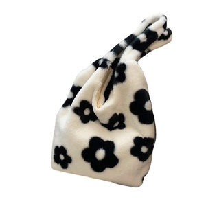 Minimalist white faux fur tote bag featuring a large black daisy pattern and soft plush texture