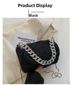 Close-up of black rhinestone cylinder bag with chunky silver chain and zip closure