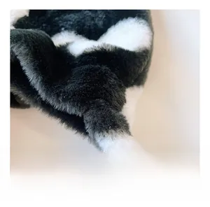 Close-up of soft plush shoulder strap with black and white spotted faux fur texture