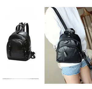 Detail view of mini black washed leather backpack with double strap and vertical zipper