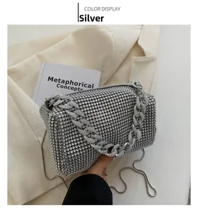 Detail of silver rhinestone evening bag with chunky chain handle and snake chain