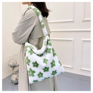 Detail of plush tote bag showing green flower pattern and soft faux fur texture