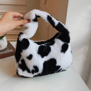 Plush cow print shoulder bag with soft faux fur texture for winter fashion styles