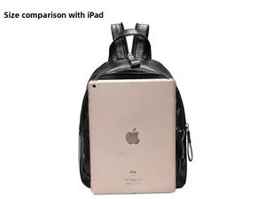 Detailed size comparison of the black leather backpack next to a 9.7 inch iPad