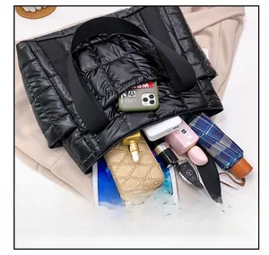 Macro shot showing large interior capacity of black quilted tote bag with daily essentials