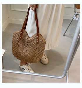 Summer woven straw tote bag with brown leather handles and chevron pattern for beach