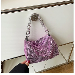 Detail view of pink rhinestone handbag with a thick silver chain strap for parties
