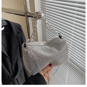 Detailed view of silver rhinestone handbag with chunky chain handle and crossbody strap