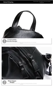 Detail of reinforced top handle and metallic zipper on a black pebbled leather backpack