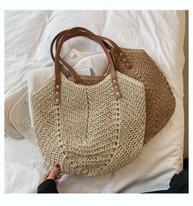 Detailed V-shaped woven texture of cream and brown straw tote bags with leather straps