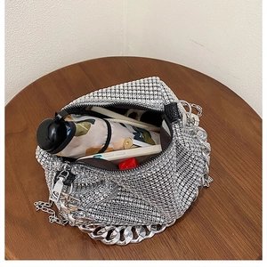 Interior view of silver rhinestone handbag showing capacity for phone and umbrella