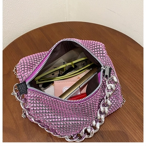 Detailed view of pink rhinestone bag showing chain strap and interior storage space