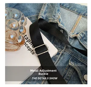 Detail of silver rectangular metal buckle on black nylon adjustable strap for backpack