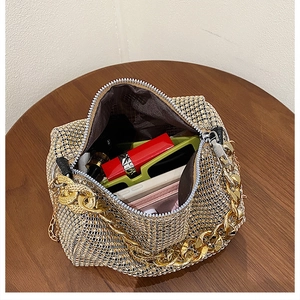 Top view of rhinestone evening bag with gold chain handle and interior storage details