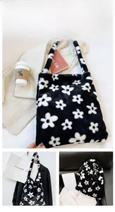Detail of plush tote bag with black base and white flower pattern in lifestyle setting