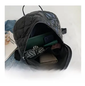Interior view of black quilted backpack showing spacious compartments and storage