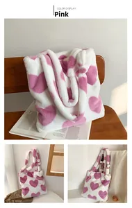 Close-up of fluffy white tote bag with large pink hearts and soft plush handle