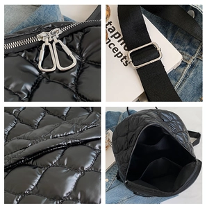 Detail view of black quilted backpack with metal zippers and adjustable nylon straps