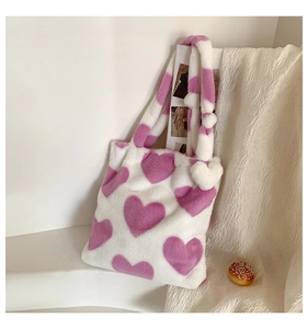 Detail of soft plush tote bag with purple hearts on white faux fur and thick strap