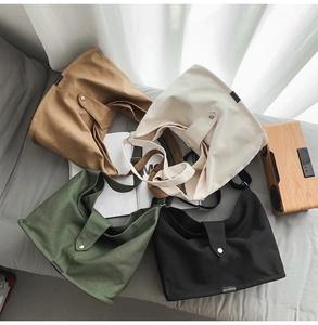 Detail view showing canvas crossbody bags in brown, beige, green and black colors