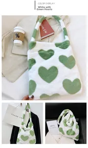 Detail of soft plush tote bag featuring green heart patterns on white faux rabbit fur texture