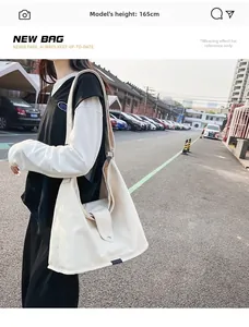 Large off-white canvas bag shown on a 165cm model in an outdoor urban setting