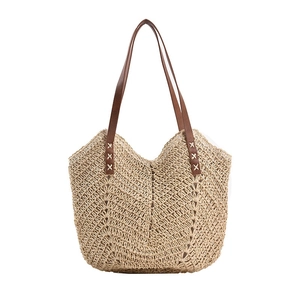 Large straw tote bag with wave pattern texture and brown leather shoulder straps