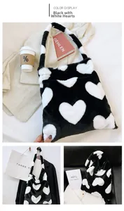 Detailed view of plush tote bag texture with black and white heart pattern