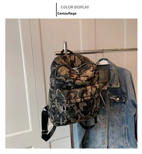 Detail of quilted camouflage backpack showing the waterproof nylon fabric and zipper pocket