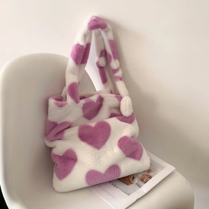 Chic plush tote bag featuring purple heart patterns on soft white faux fur for winter style