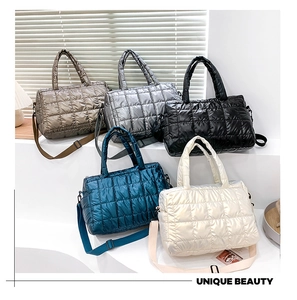 Macro shot of quilted down tote bags in champagne, metallic grey, black, blue and white
