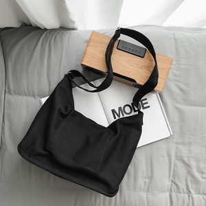 Minimalist large capacity black canvas crossbody bag with adjustable wide strap and front pocket